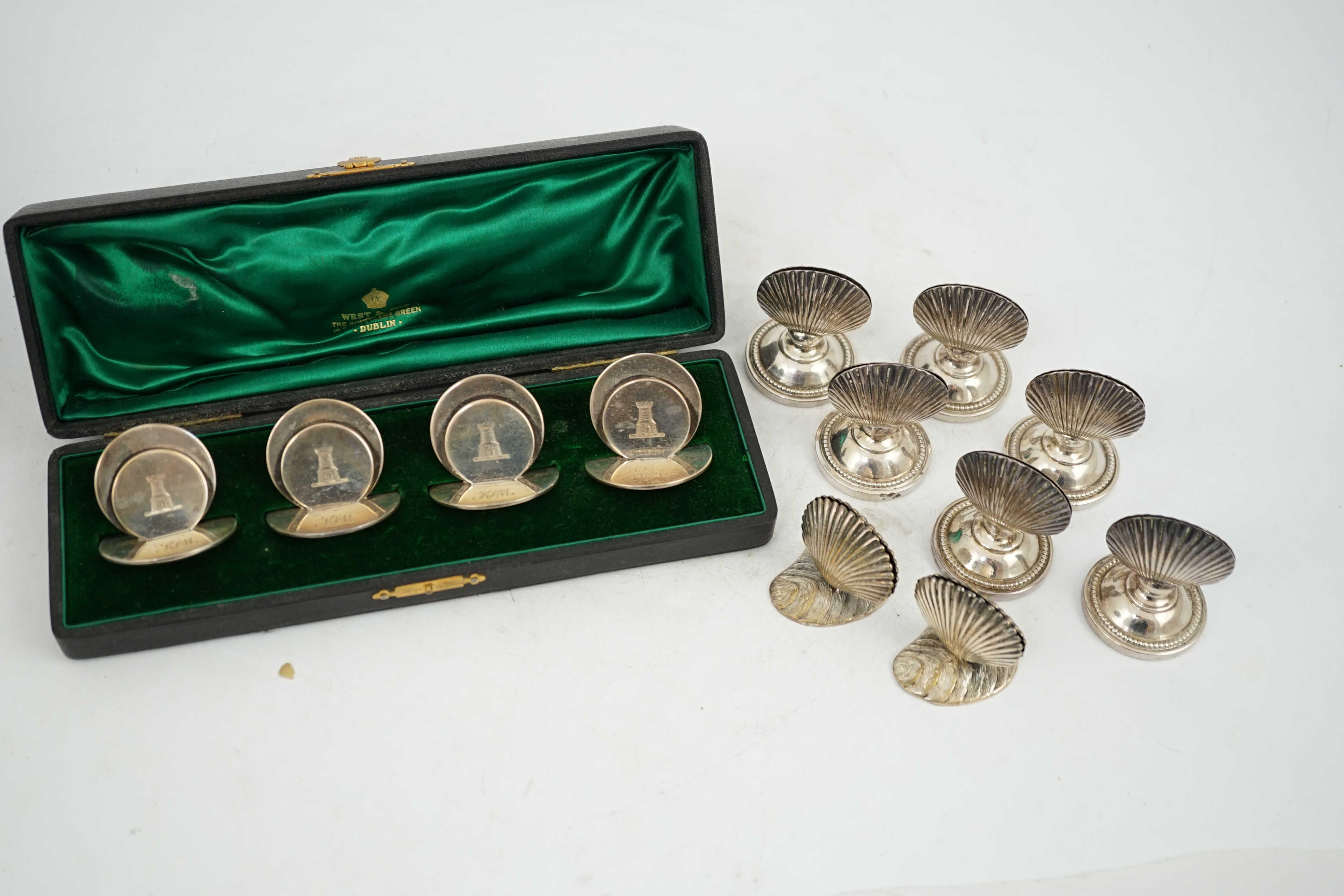 A cased set of four silver menu holders, engraved with castle crest, Sampson Mordan & Co, Chester, 1904, height 37mm, together with eight plated menu holders